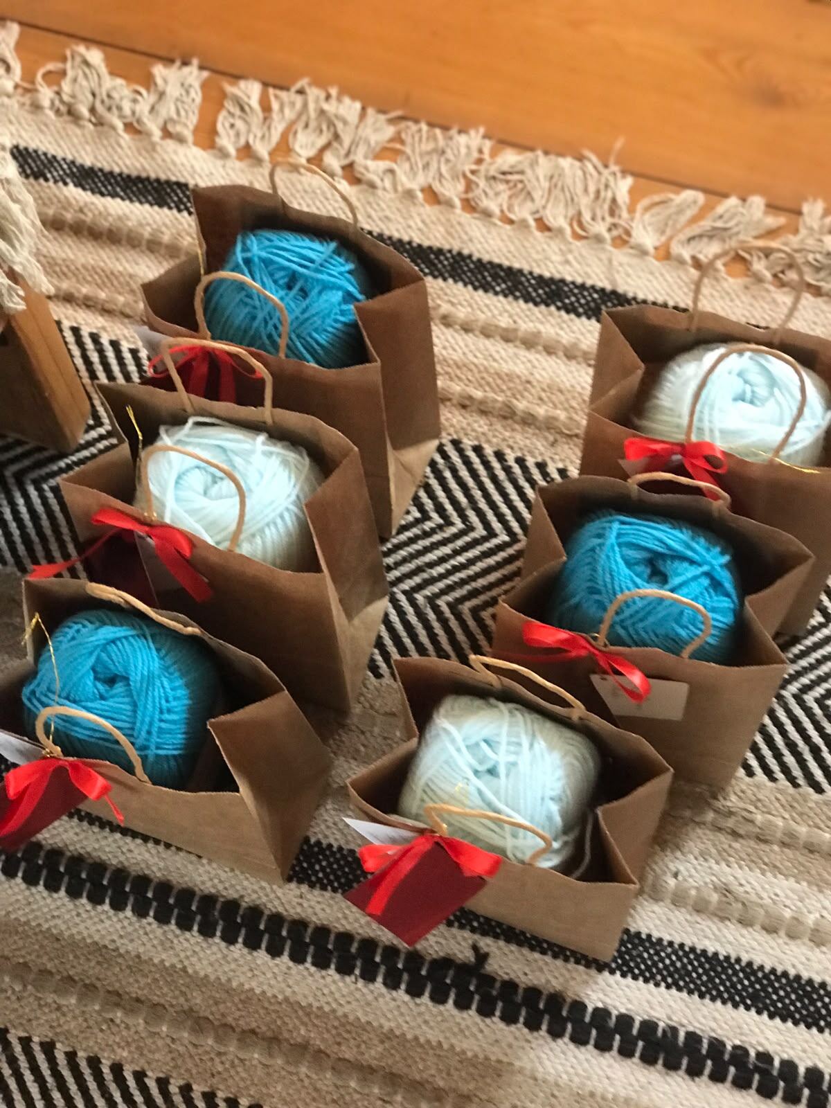 Gift bags of yarn tied with ribbon for the Moments for Me event